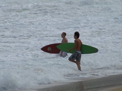 Surfers heading out