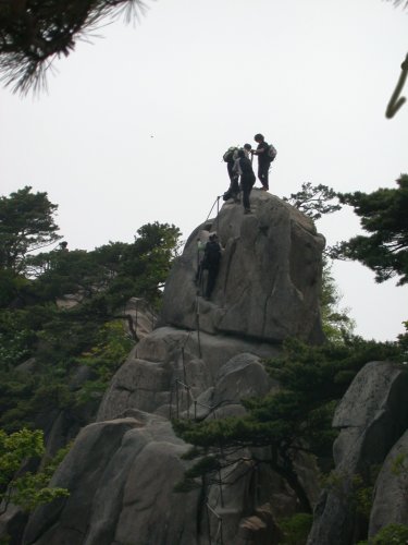 climbers atop a rock