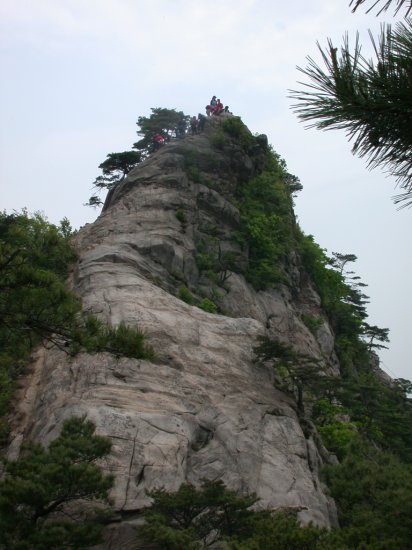 hikers atop spectacular rock