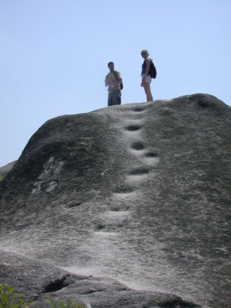 tourists atop a rock